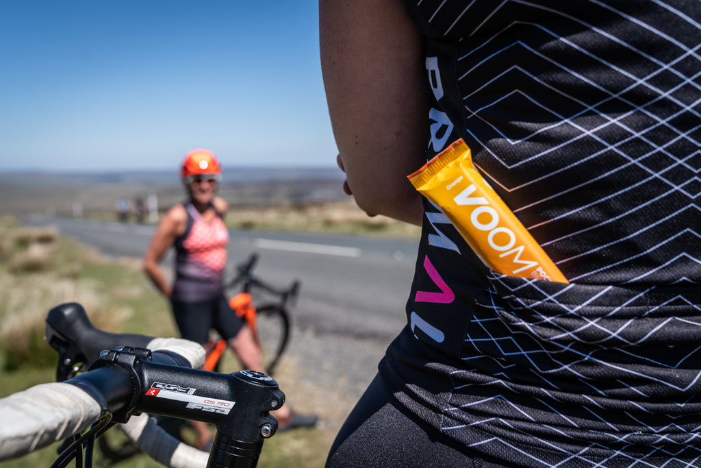 An orange flavour Beta Blast Pocket Rocket in a cyclists rear jersey pocket