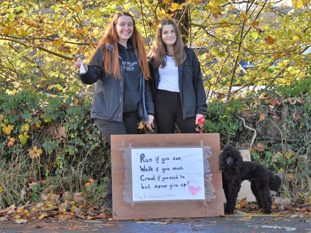 Two girls show support for the Brathay 10in10 runners with a home made sign