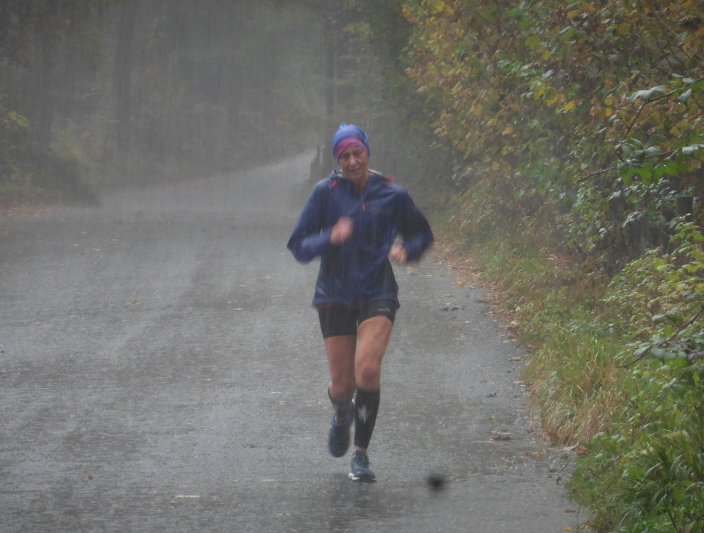 Dianne Morris running through thrashing rain as she makes her way around the Brathay 10in10