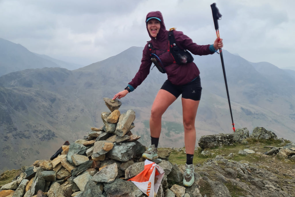 A female ultra runner at the summit of a Wainwright fell during the Great lakeland 3 Day event 2022