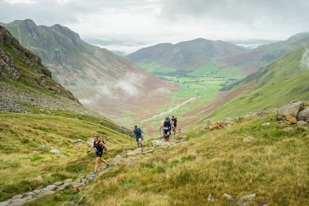 Ultra runners climb up out of the Langdale Valley as part of the 13 Valley route in the Lake District, England.