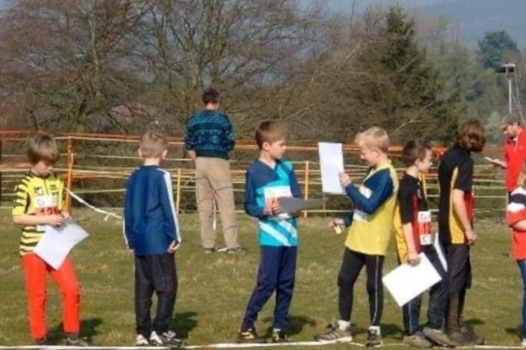 Junior orienteers, including a young Nathan Lawson, receive certificates after completing an orienteering event.