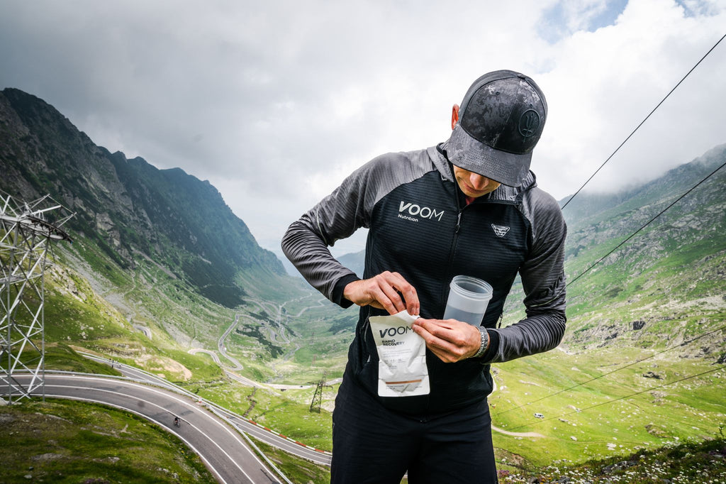 Beau Smith VOOM cyclist mixes a Rapid Recovery protein shake at the top of a cycling climb