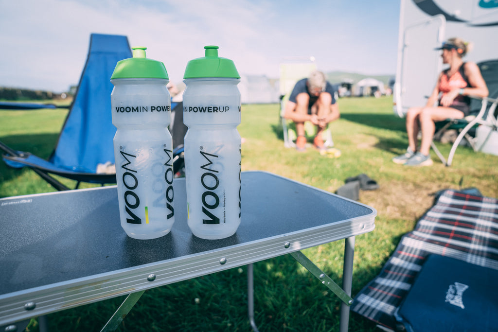 Two VOOM Water bottles on a table in camp during a multi day event
