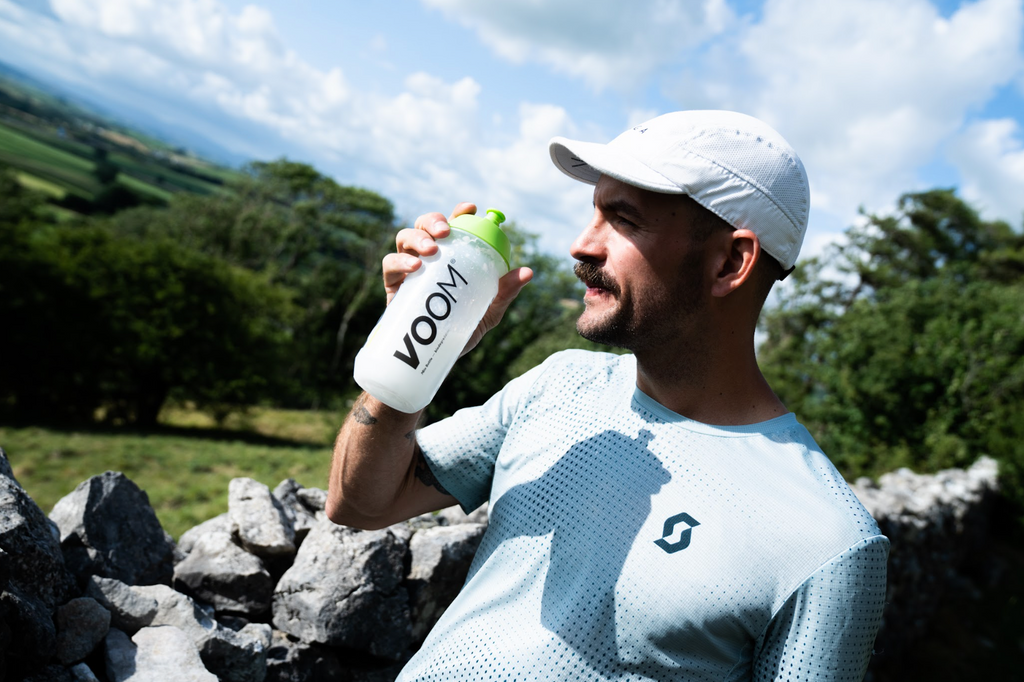 VOOM ultra and fell runner Ellis Bland drinking VOOM carbohydrate energy drink Fusion Fuel whilst on a break during a trail run