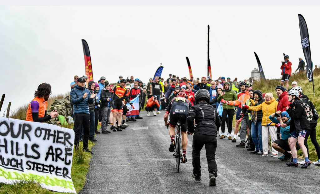 Crowds cheer on a rider heading up the final steep stretch of The Struggle hill climb near Ambleside in the Lake District