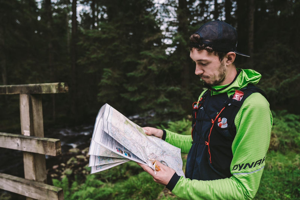 A male runner looking at a map and making plans for training
