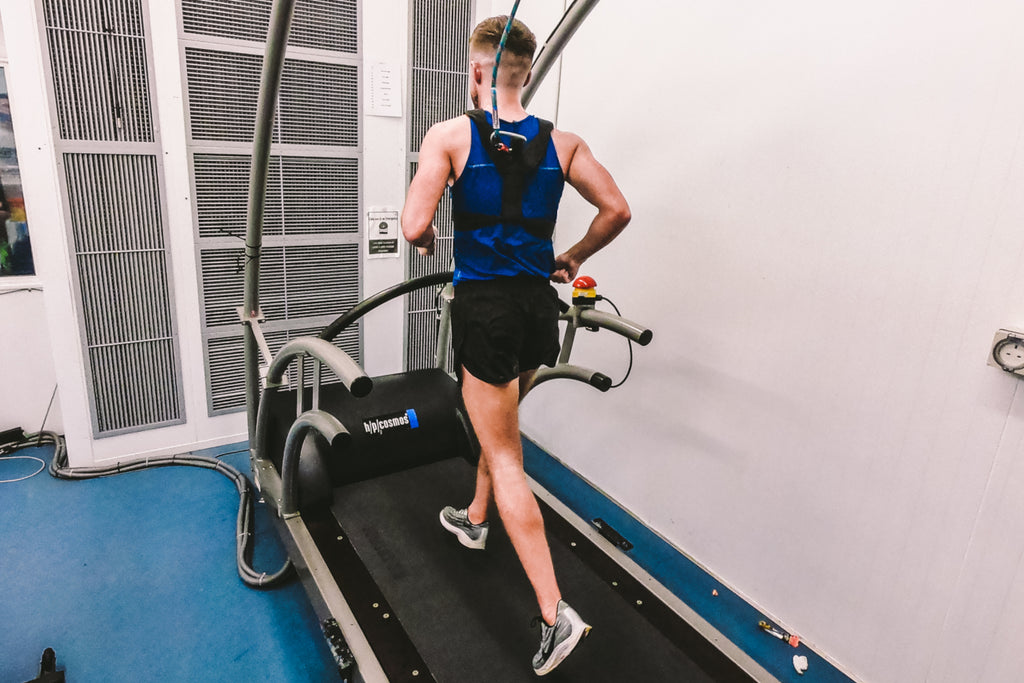 A male runner on a treadmill undergoing a sports science testing protocol.