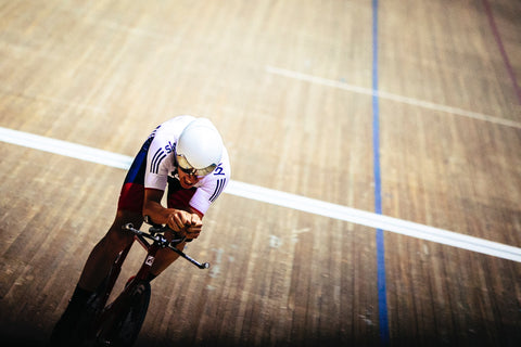 Aerodynamic cyclist on the wooden boards of a velodrome