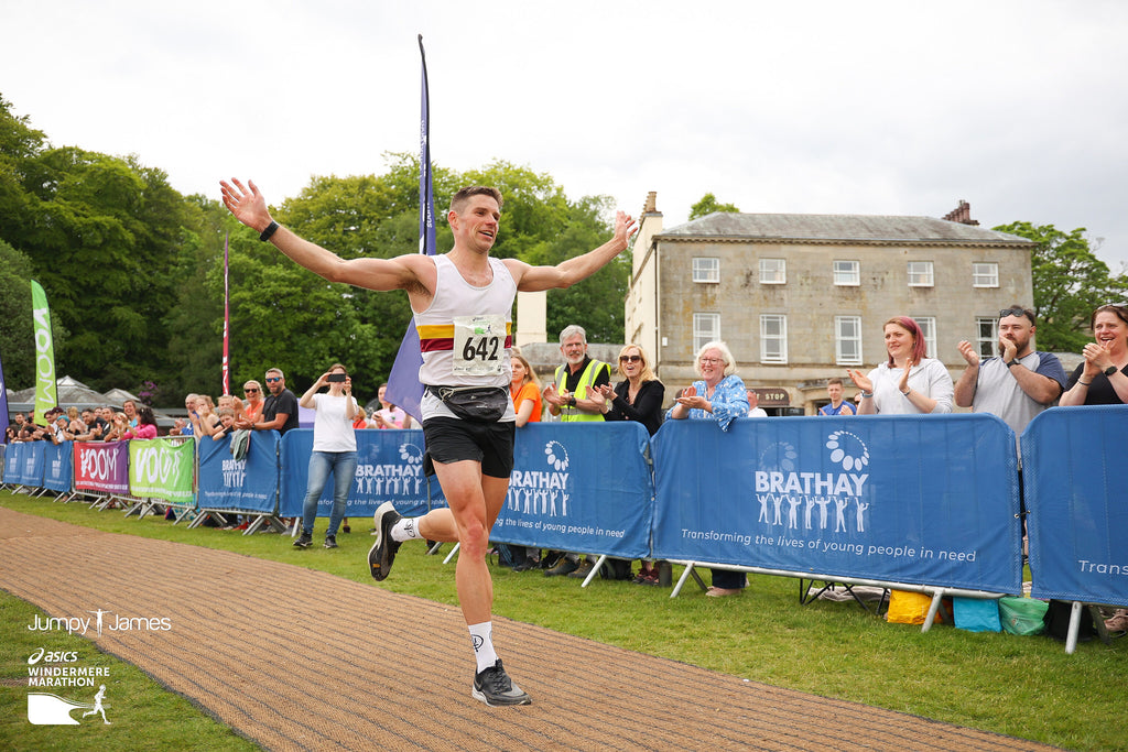 VOOM Sports Scientist Beau Smith crossing the Windermere Marathon finish line in first place in the 2023 event.