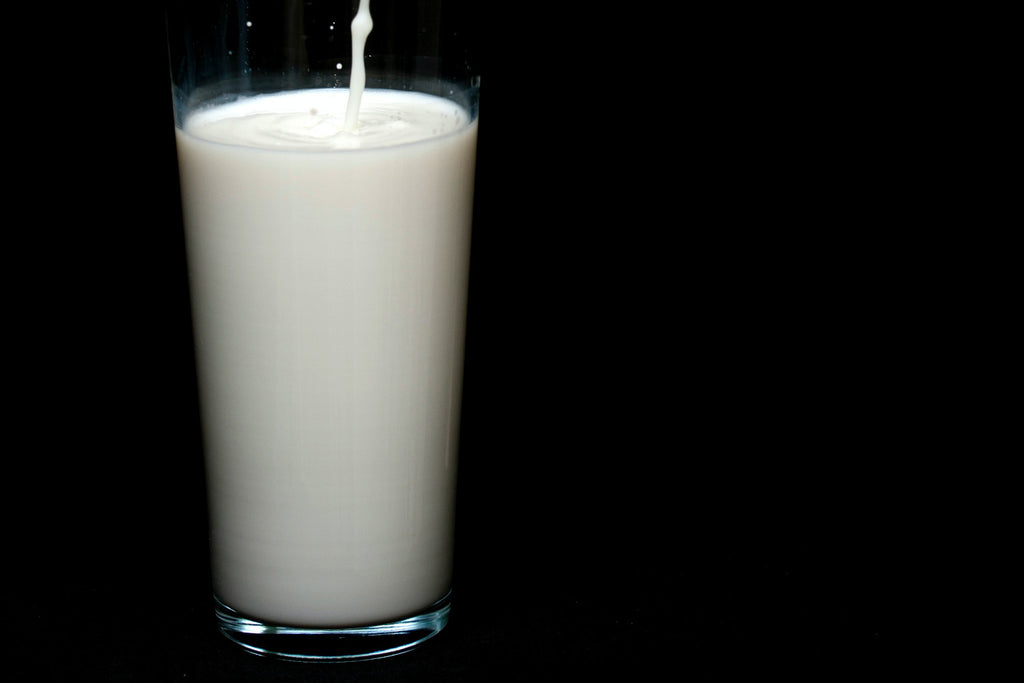 A glass of milk on a black background