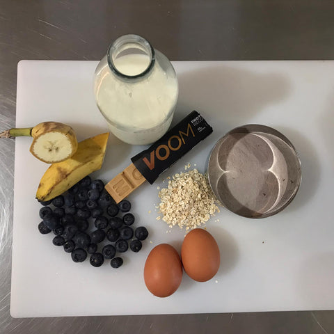 Ingredients for Voom Nutrition protein pancakes including milk, eggs, oats, banana, blueberries and RecoverFudge
