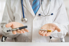 Doctor holding cigarette and e-cigarette