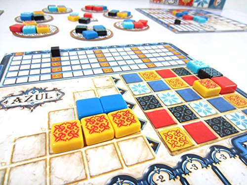 Close-up of the board game Azul showing pretty multi-colored patterned square tiles that get arranged on a grid into patterns for a visual game