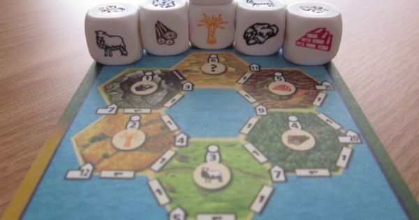 Picture of a Catan Dice sheet from the scorepad, which has a colorful map and spaces for adding points and collecting resources, with the special dice