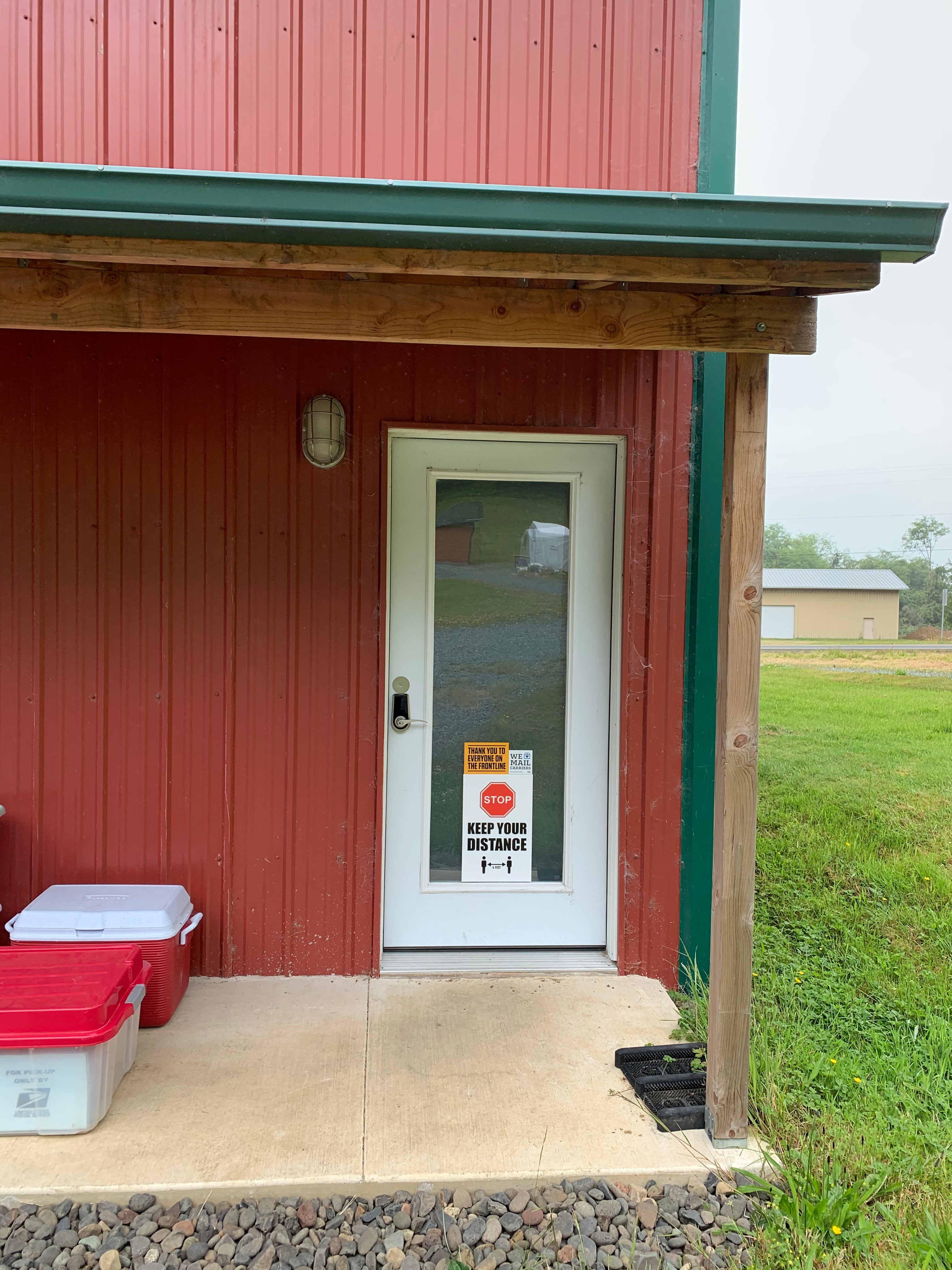 Workshop door with COVID signs