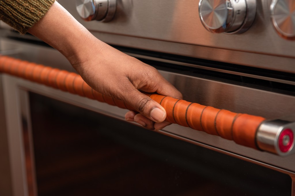 Warm and Insulating Honey Leather Handle Wrap on Stainless Steel Stove Door