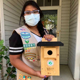 girl scout holding birdhouse