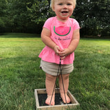 toddler girl standing in bird feeder