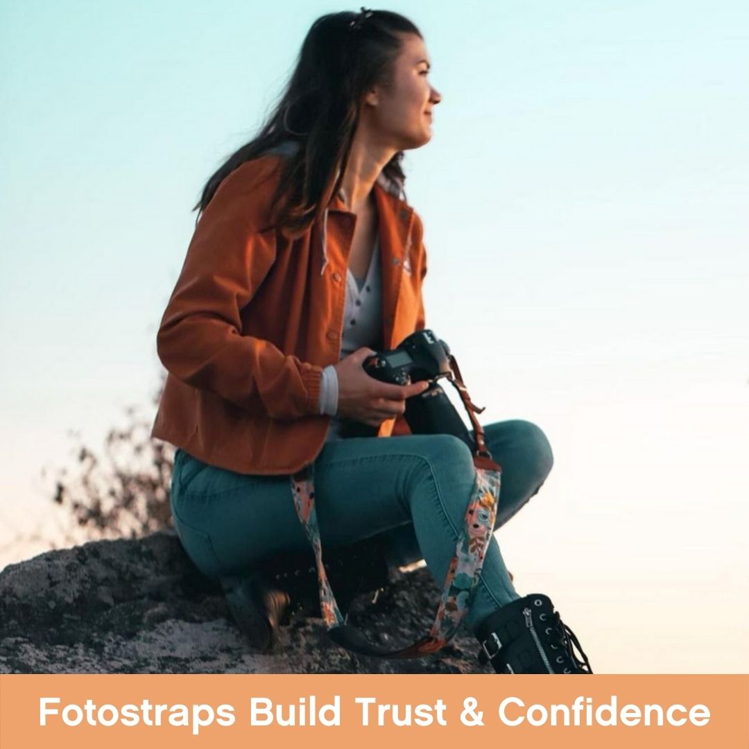 Lady on Mountain Top Holding A Digital Camera with a Fotostrap