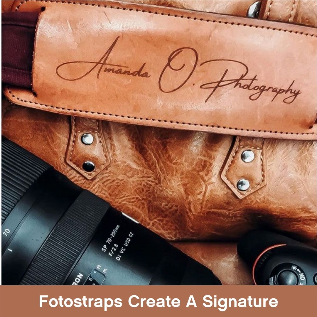 Fotostrap shoulder pad with photographer logo sitting on leather bag