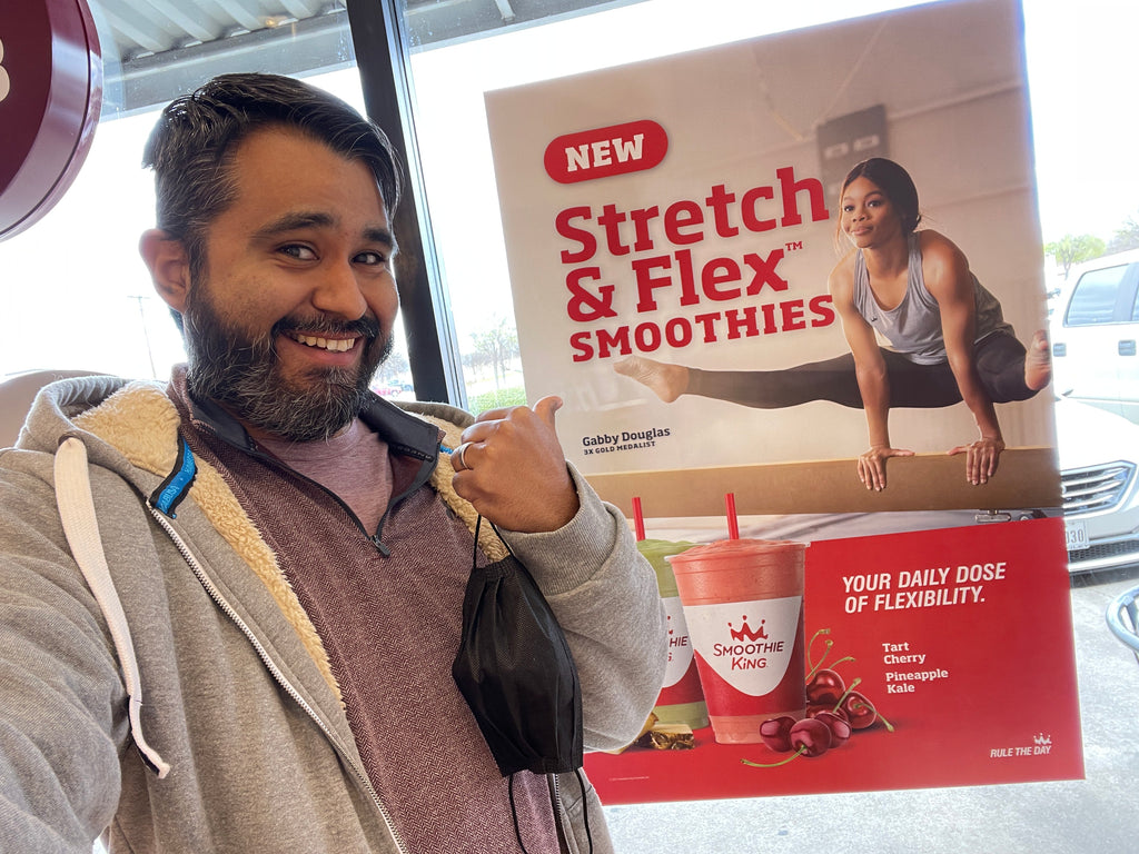 Jared next to poster of Gabby Douglas at Smoothie King