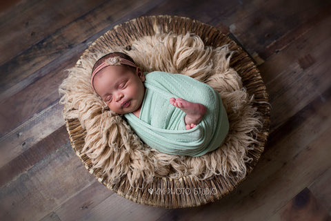 Newborn baby sleeping in basket