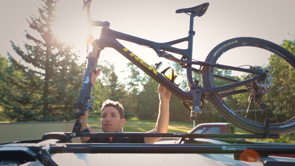 Kelly Magelky putting his bike on his bike rack