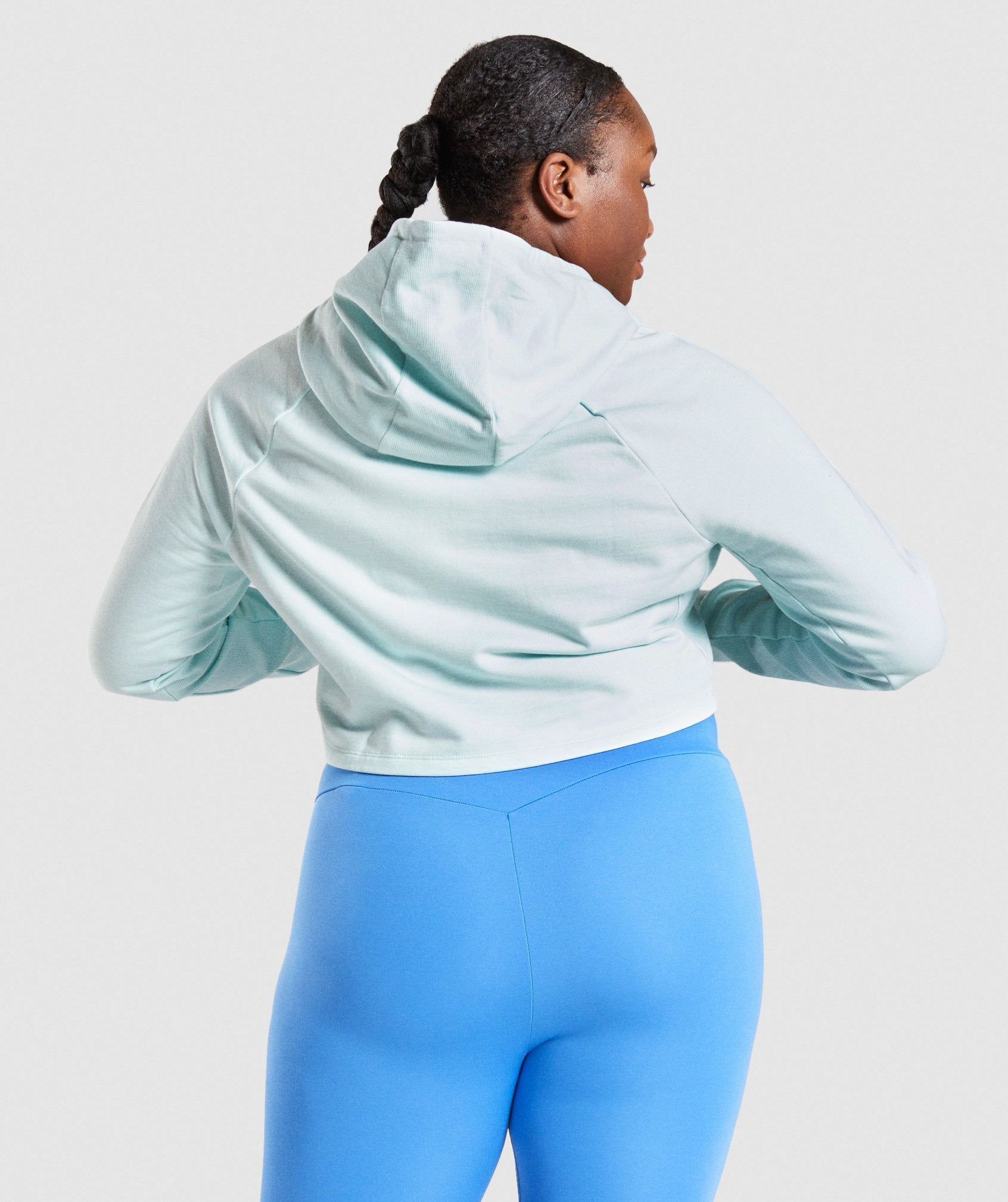 Image B shows back of model wearing Training Cropped Hoodie in Light Green