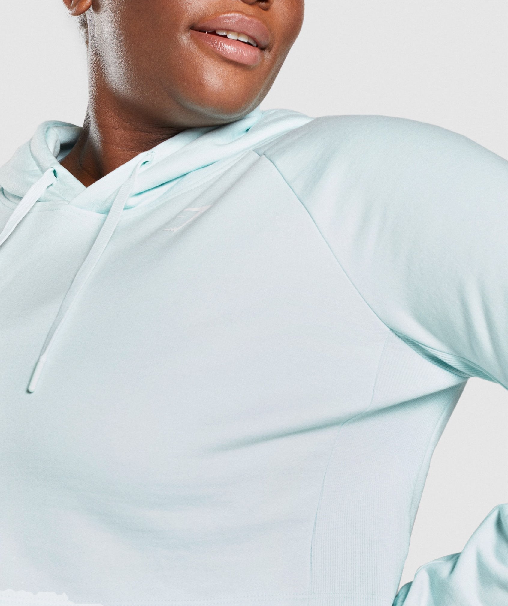 Image D2 show a close up of the front of the Training Cropped Hoodie in Light Green