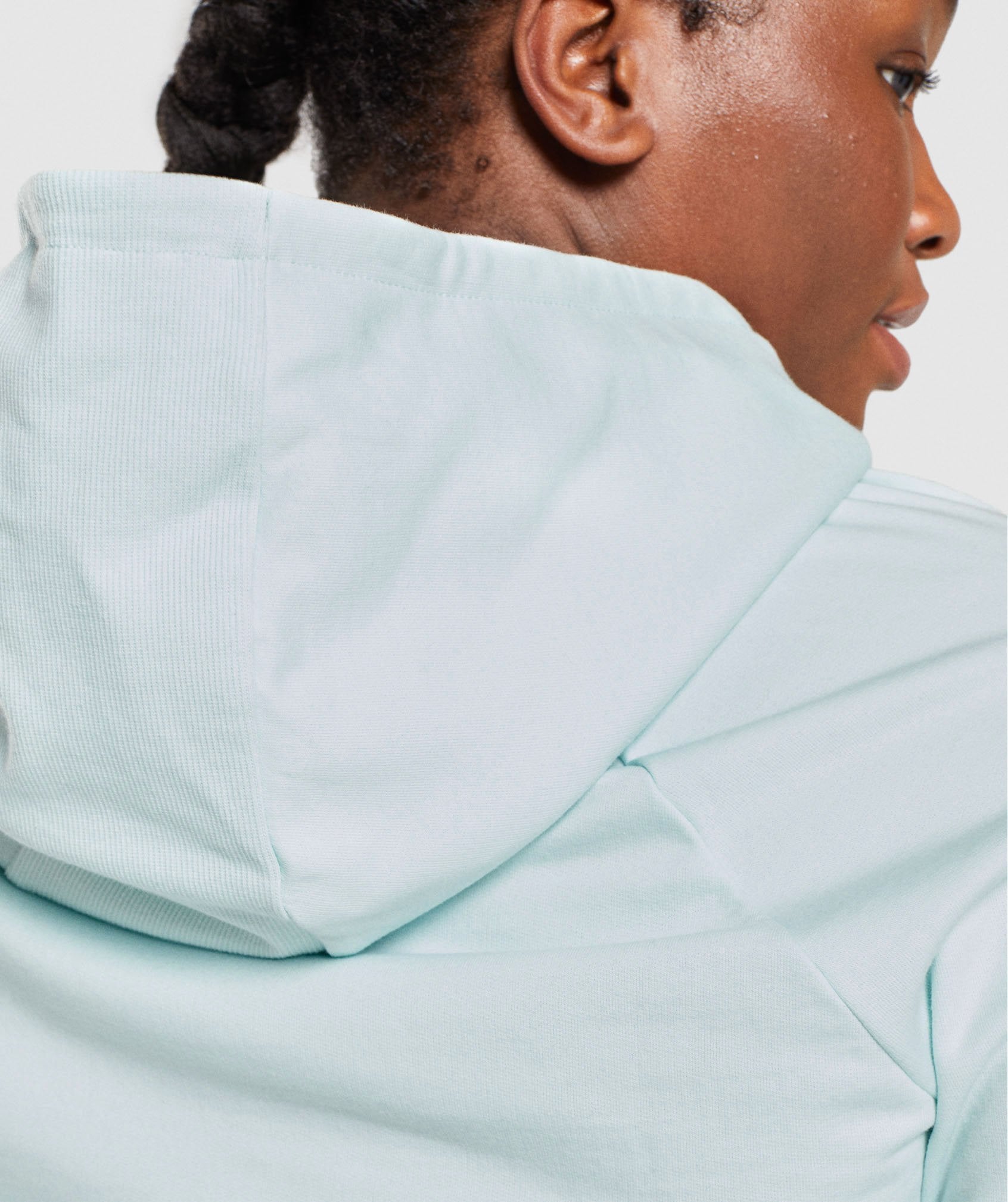 Image D3 shows a close up of back of model wearing Training Cropped Hoodie in Light Green