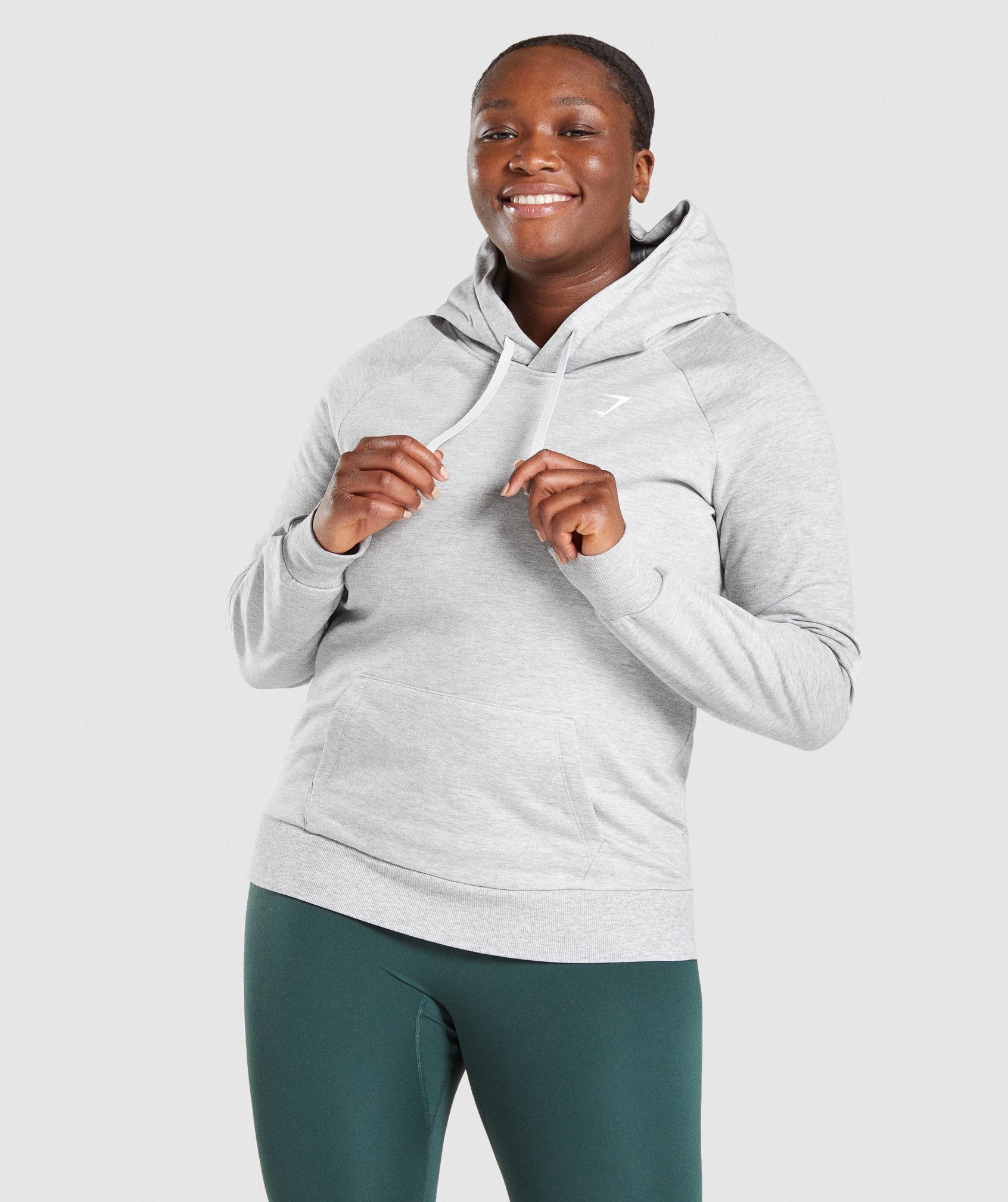 Image A shows front of model wearing Training Hoodie in Light Grey Marl