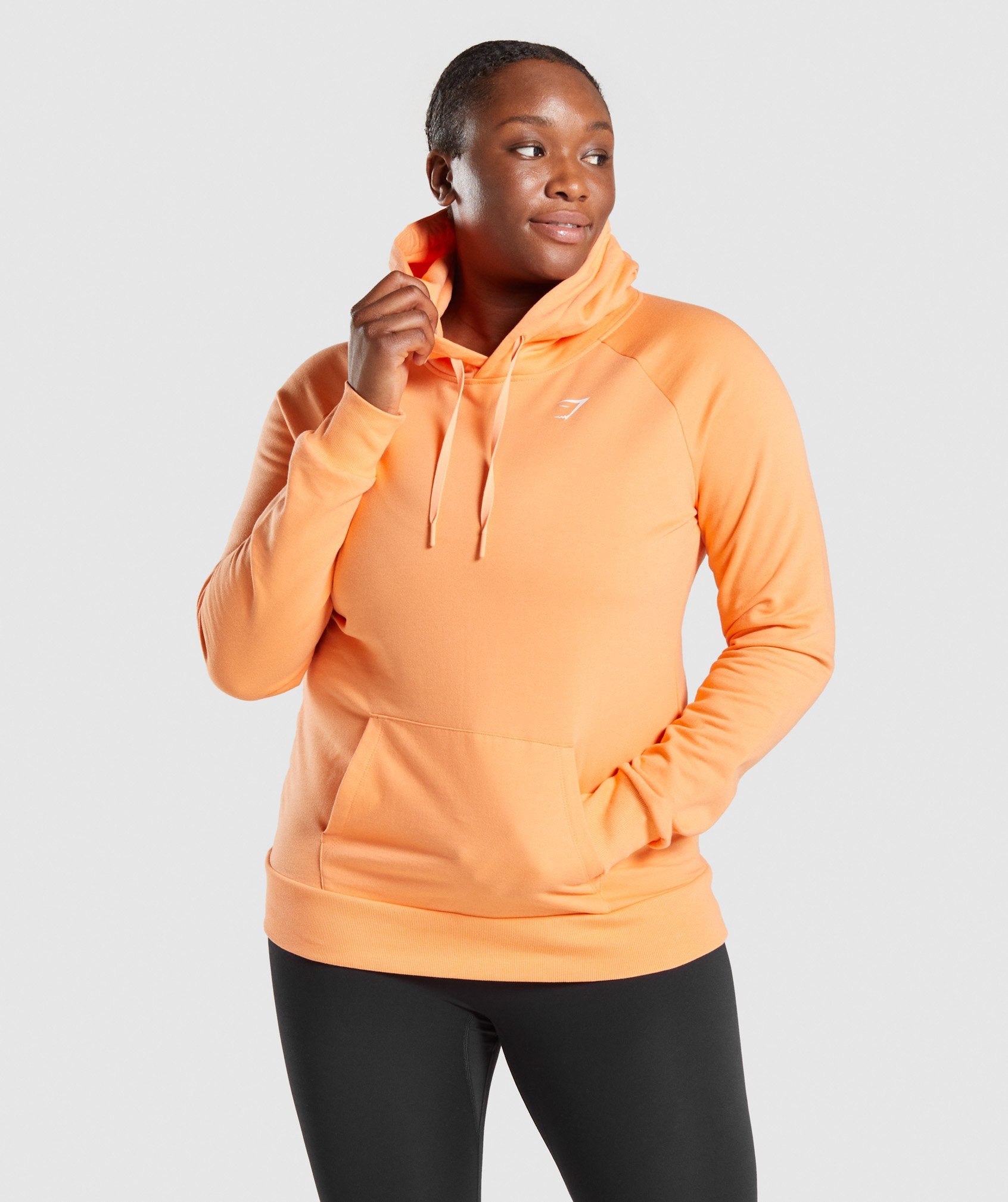 Image A shows front of model wearing Training Hoodie in Orange