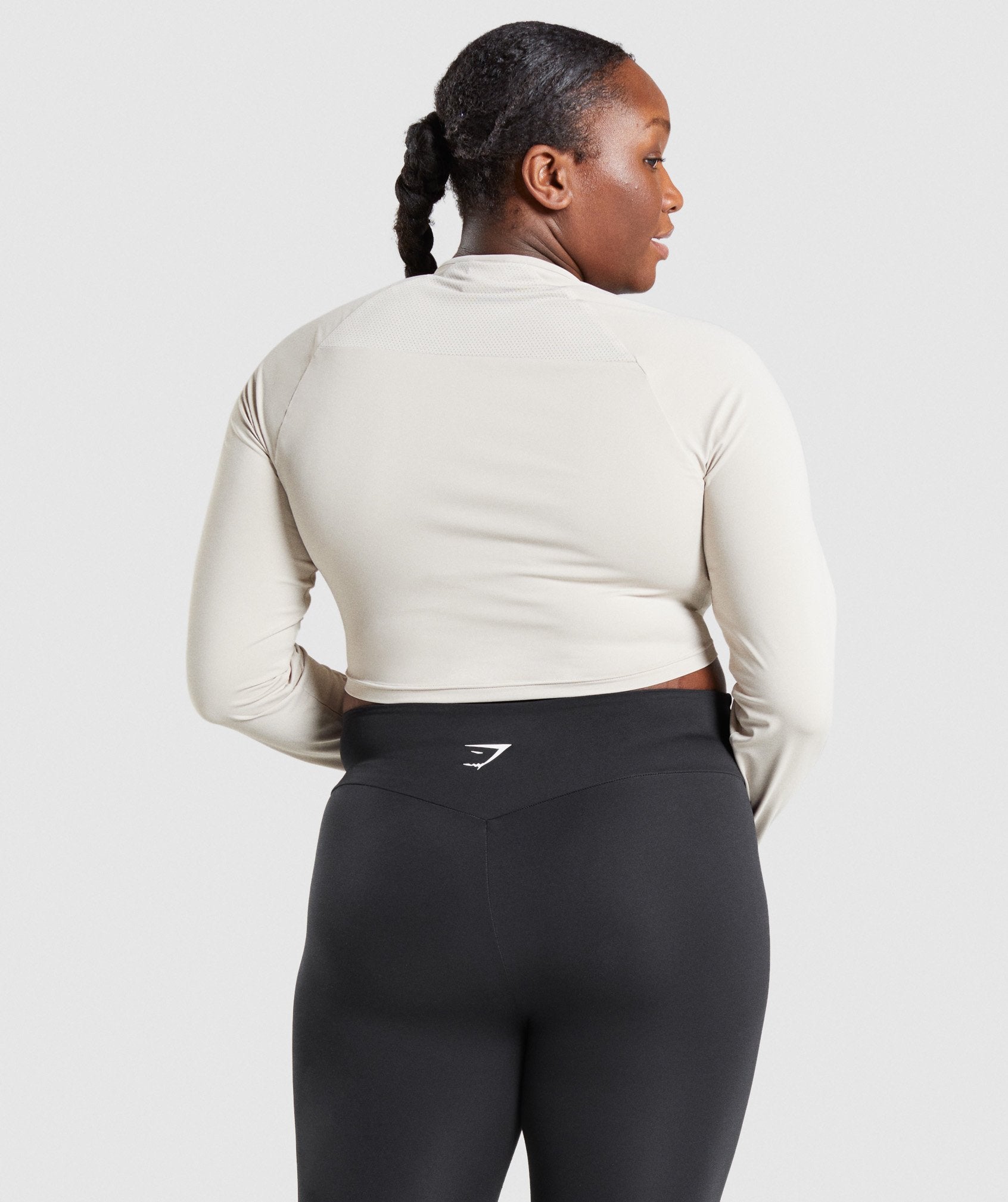 Image B shows back of model wearing Training Long Sleeve Crop Top in Grey