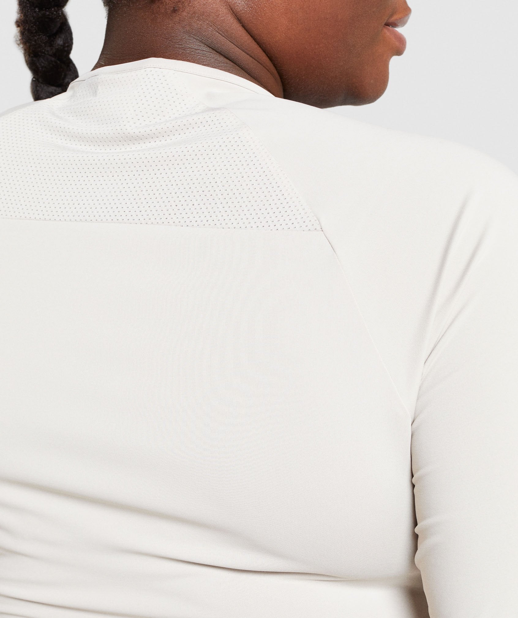 Image D2 shows a close up of back of model wearing Training Long Sleeve Crop Top in Grey