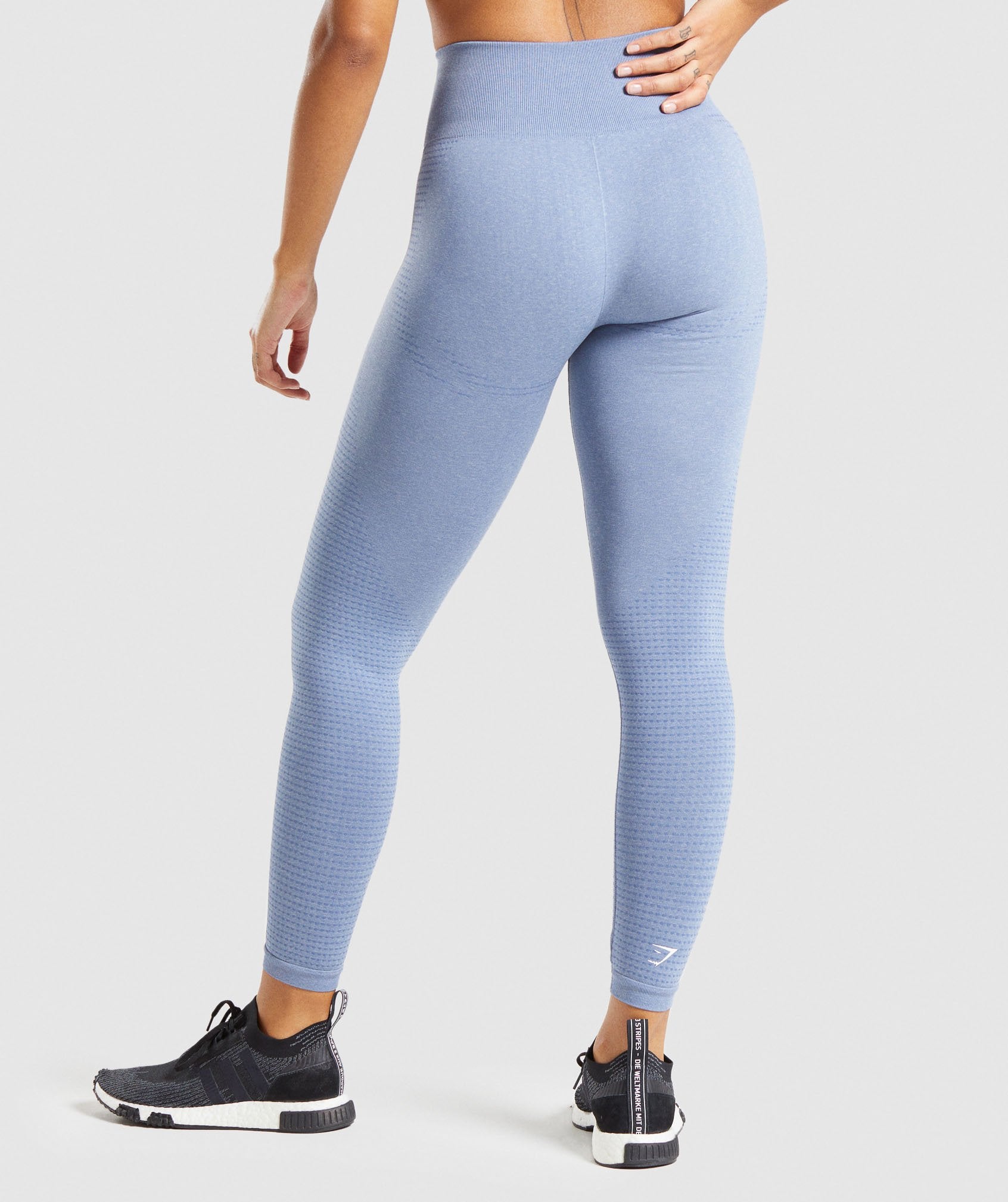 Image B shows the back of a model wearing Vital Seamless Leggings in light blue marl.