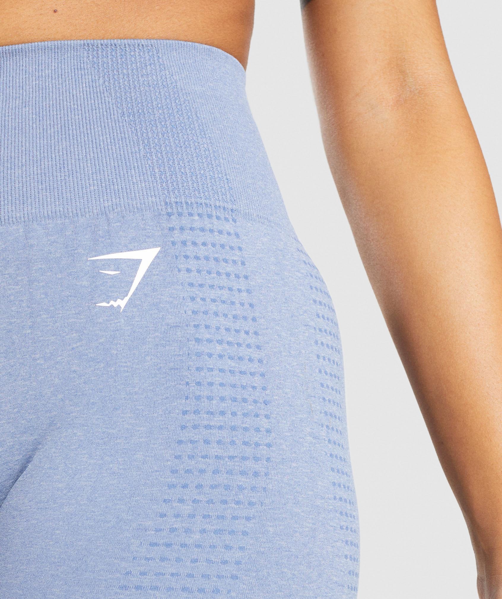 Image F shows a close up of the waistband and logo of the Vital Seamless Leggings in light blue marl.