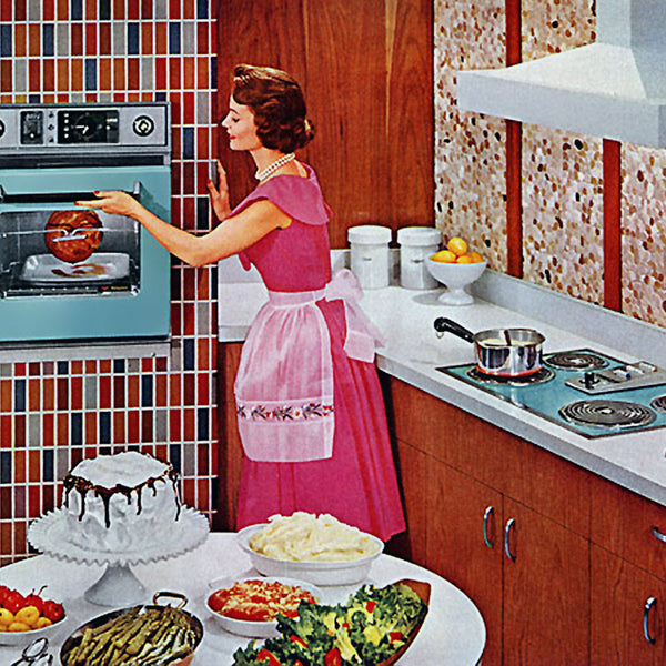 1959 suburban housewife standing in a kitchen cooking by an oven