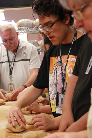 a student kneading dough