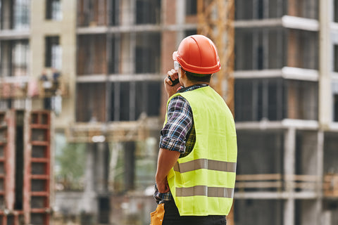 Male construction worker on site using a Motorola two way radio supplied by CTS Radios Hire Service