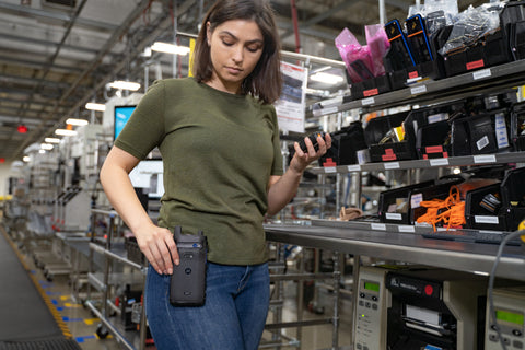 Manufacturing female with Motorola Two-Way Radio Professional Walkie Talkie