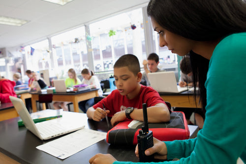 Two way radios being used in school classroom by teacher