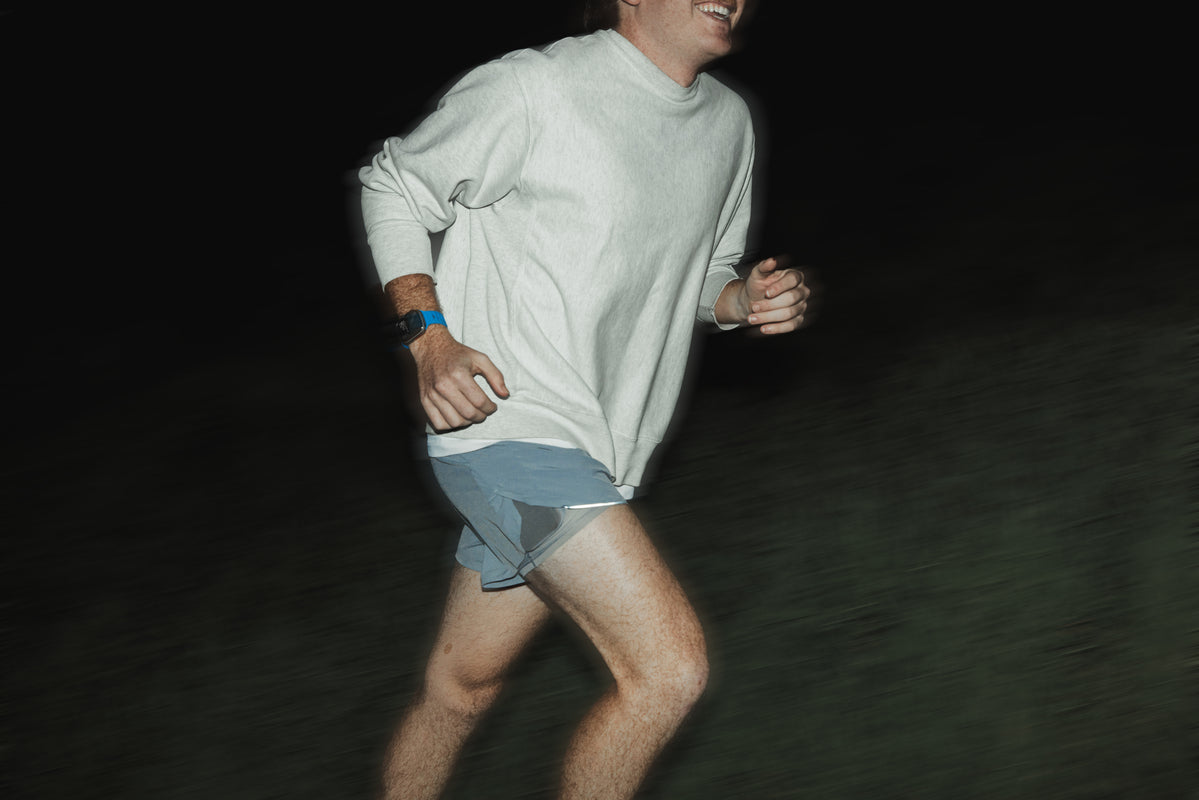 A man captured running with a Nomad Band in Electric Blue on his wrist