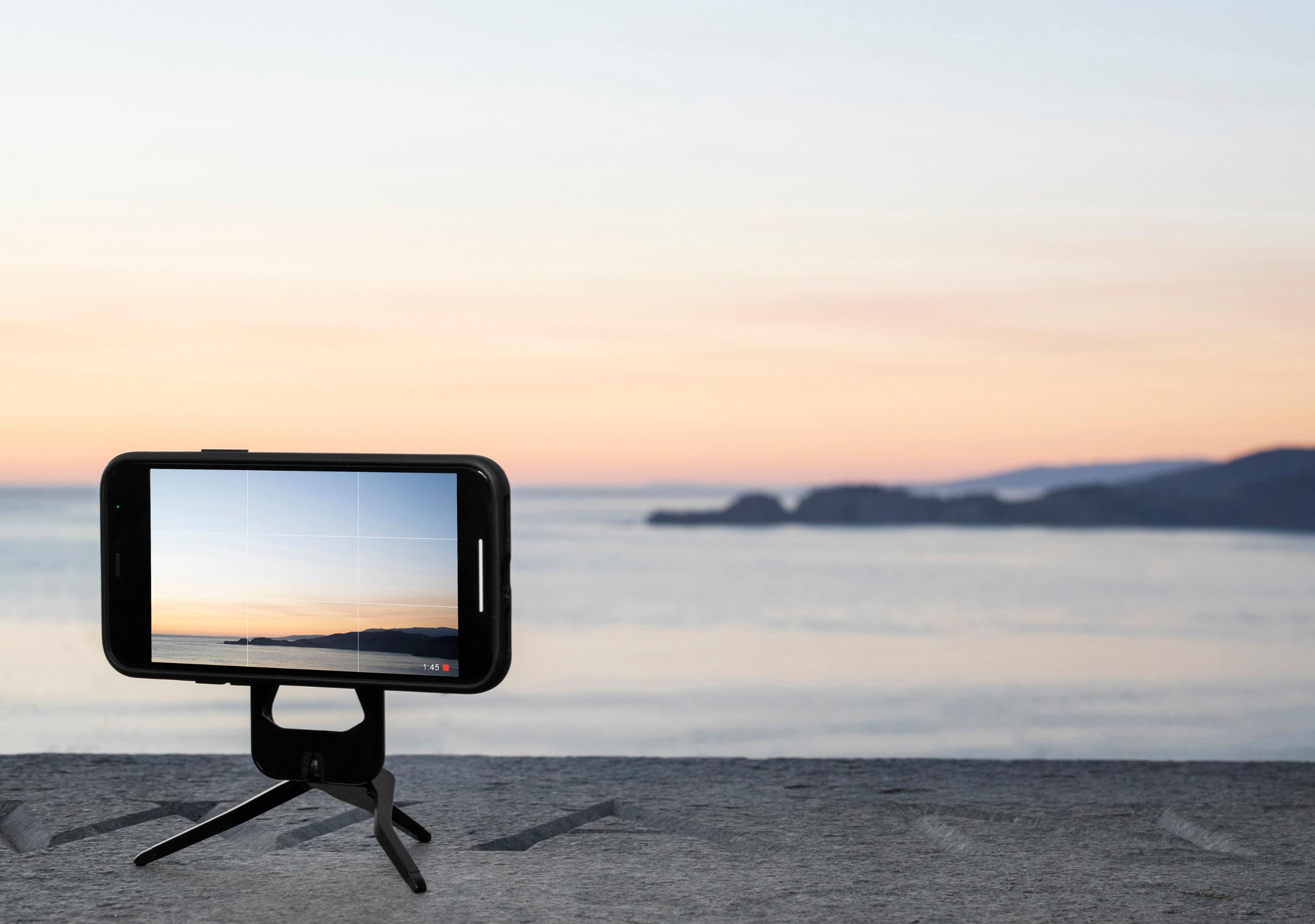 A photo of the phone standing on Peak Design's Mobile Tripod showing the sunset