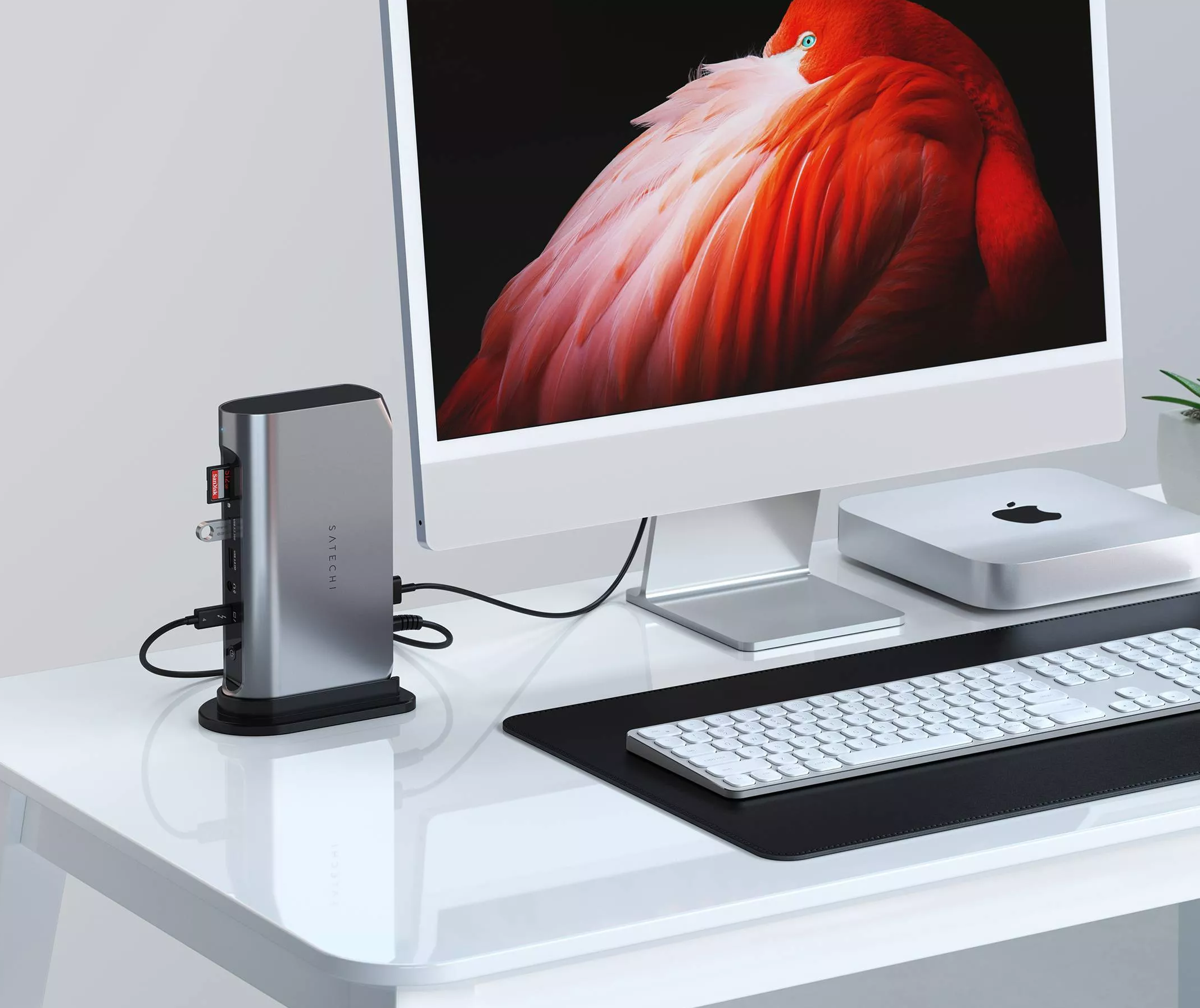 Two Mac computers on the table with the rest tech gadgets and Satechi's Multimedia Dock