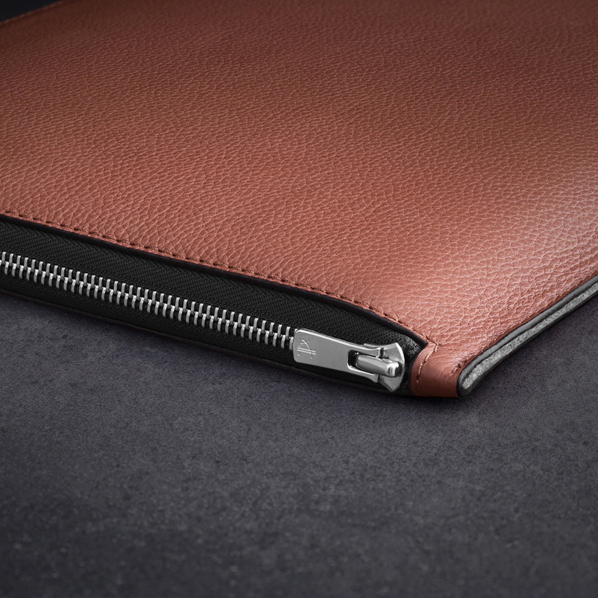 A WOOLNUT Leather Folio for 13 / 14-inch MacBook in Cognac feature with notebook, pen and pensil around