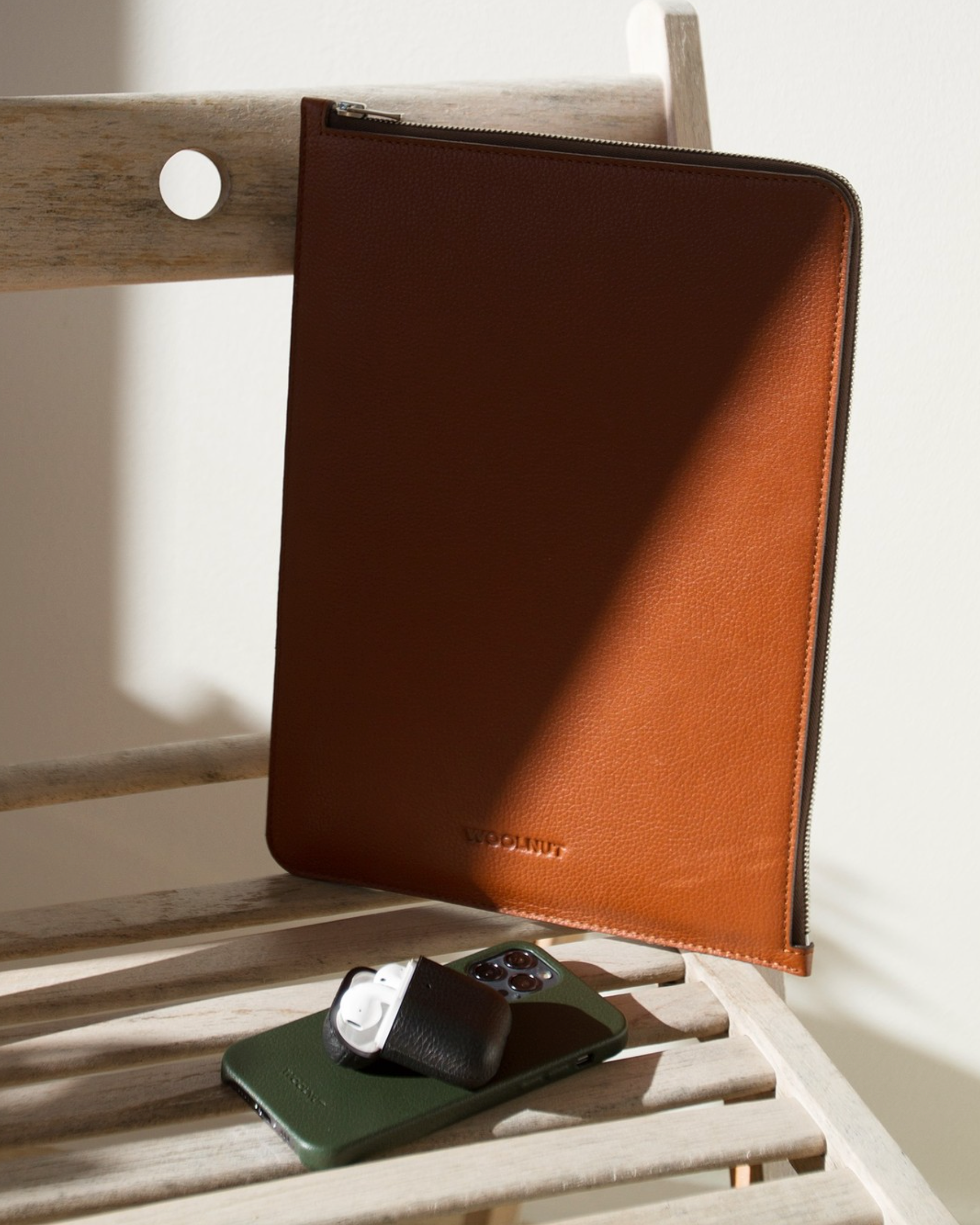 A WOOLNUT Leather Folio for 13 / 14-inch MacBook - Cognac on the table feauterd with the rest of Woolnut products