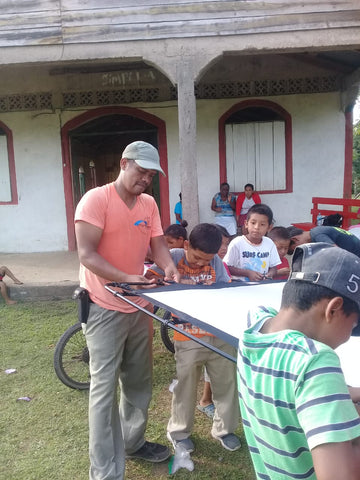 Clifford Stamp sets up the screen for the Jesus film with young charges