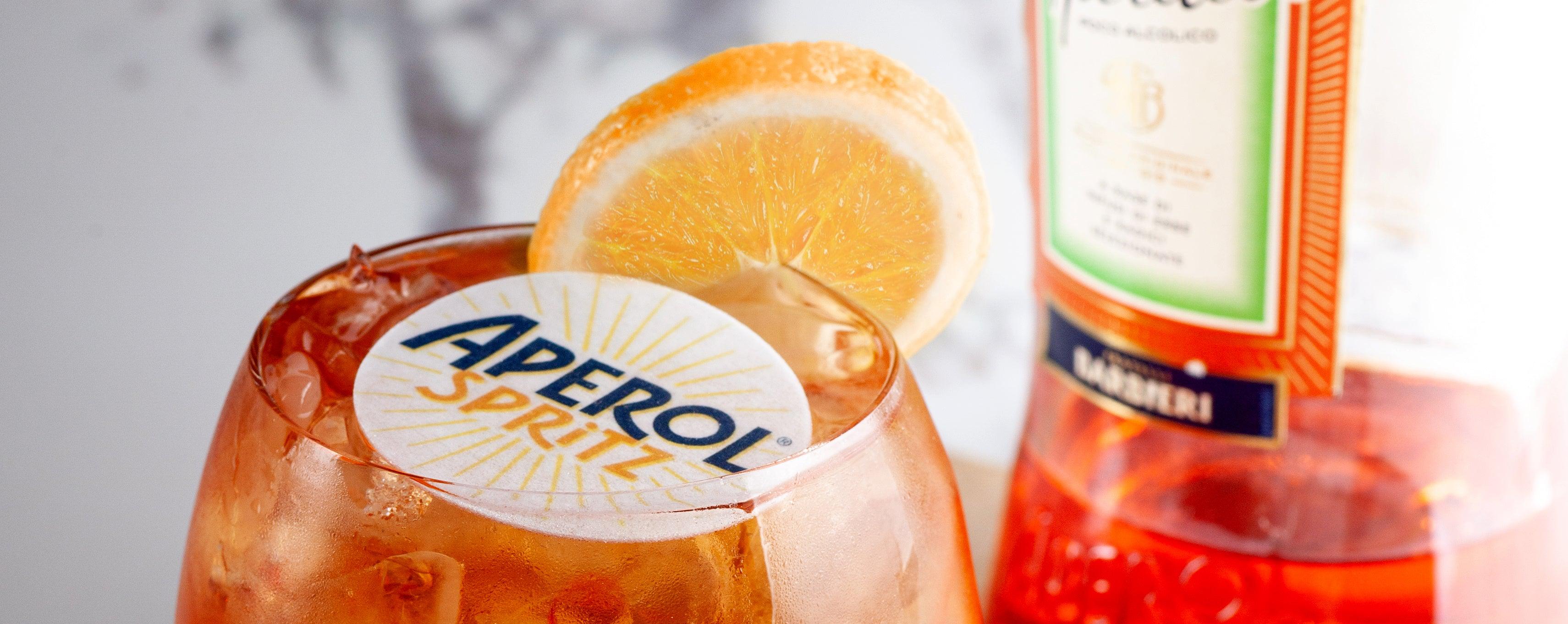 Aperol Spritz with branded cocktail topper