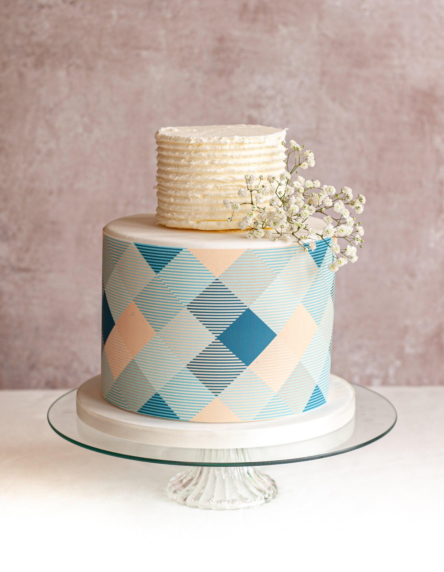 Two tier cake with blue and peach check icing cake wrap around